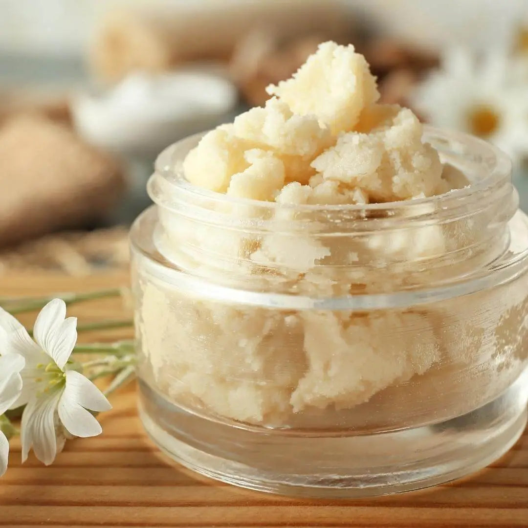 Glass jar filled with raw unrefined shea butter — a natural, organic moisturiser ideal for skin, face, hair, eczema, and stretch marks. Whipped texture perfect for African shea butter body creams and vegan skincare.