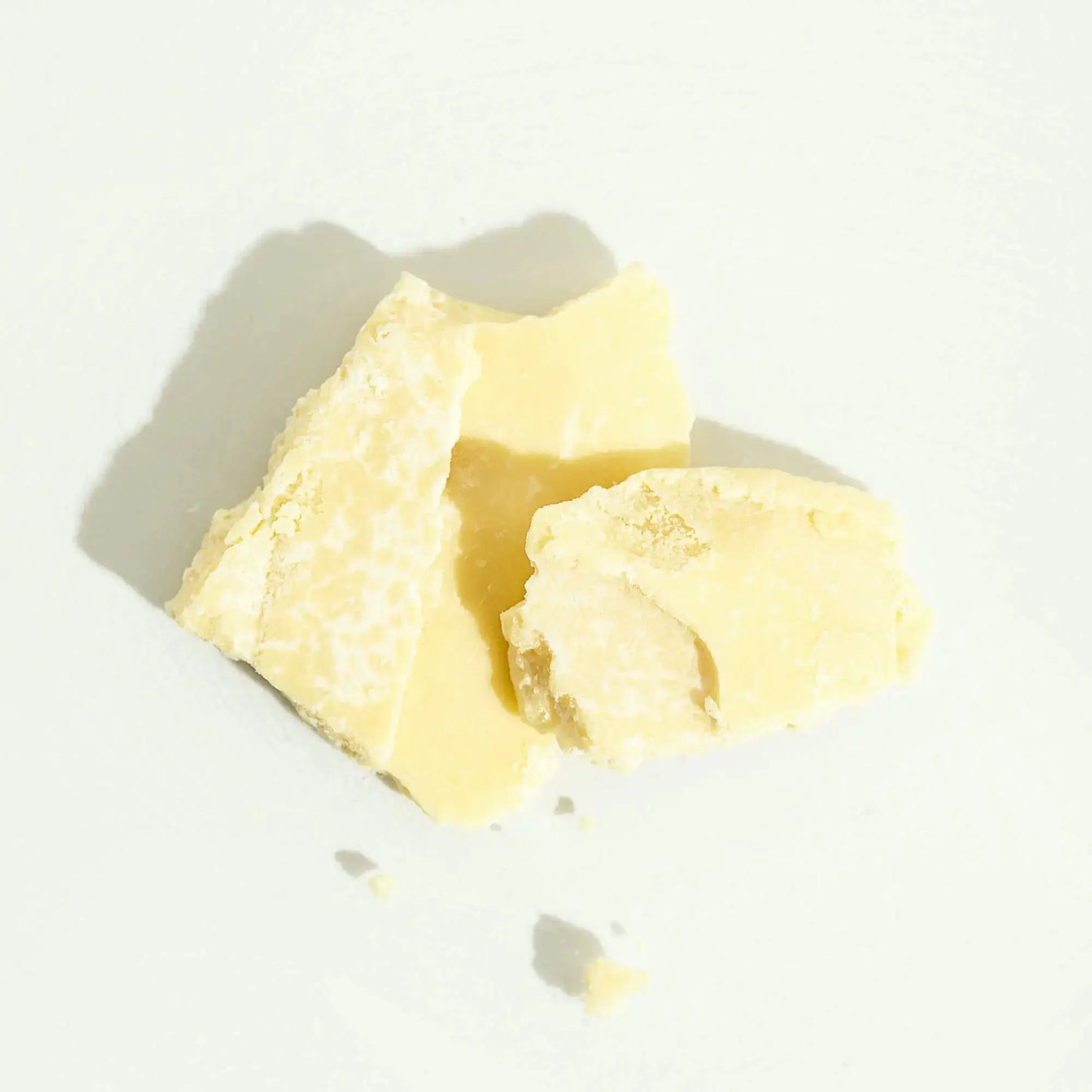 Raw unrefined cocoa butter chunks in natural form, rich in antioxidants and deeply moisturising for skin and hair — ideal for DIY skincare, body butters, and natural beauty products.