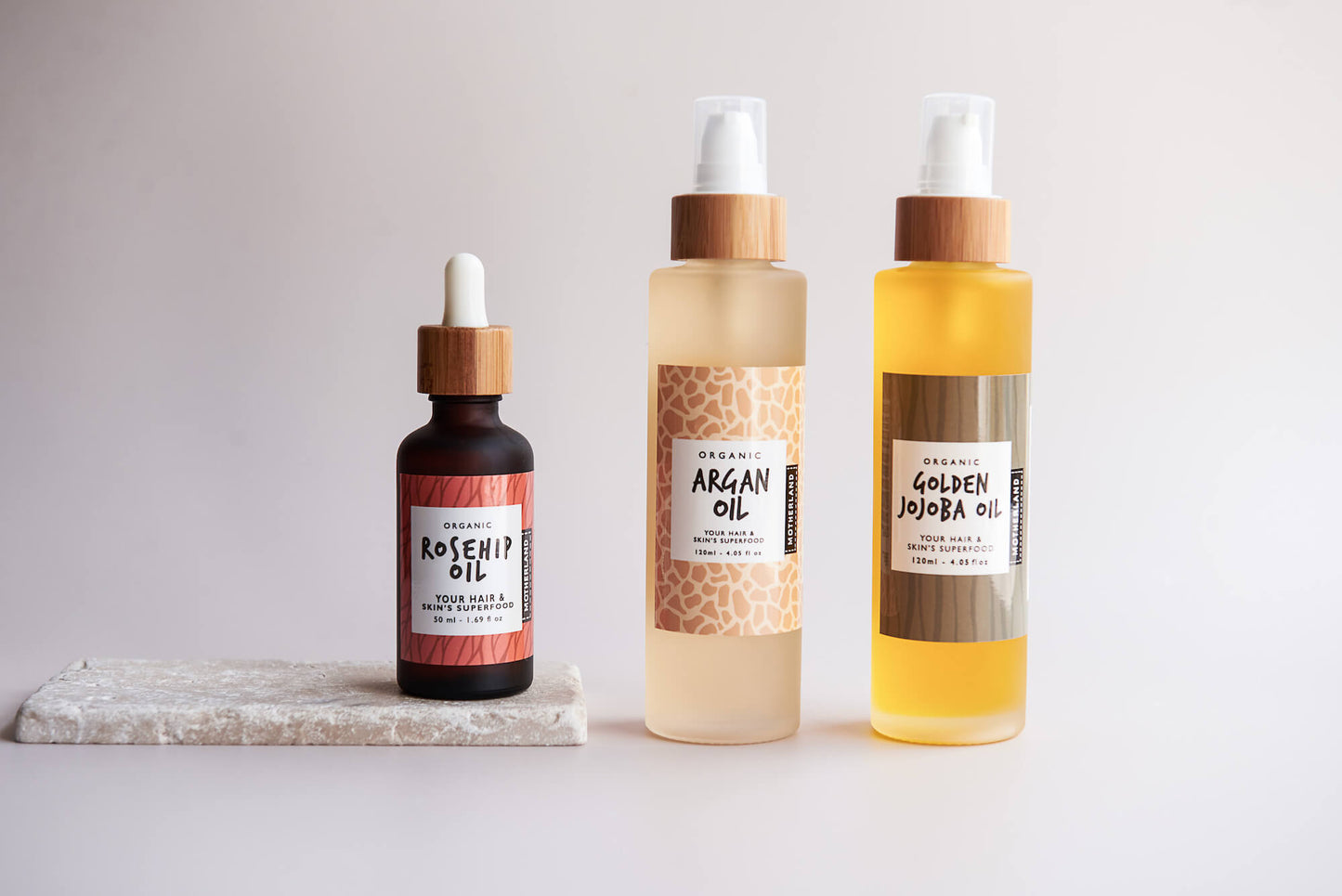 Set of certified organic oils including Moroccan argan oil for hair and skin, golden jojoba oil for face, nails and hair, and rosehip seed oil for glowing skin — ideal for moisturising, healing shine, and natural skincare routines.
