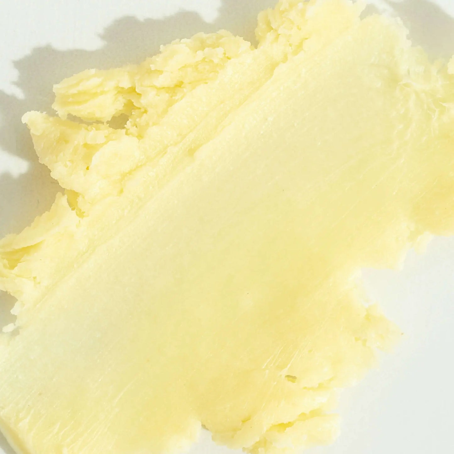 Smooth and creamy texture of ADUN whipped shea and cocoa butter – raw, organic shea butter body cream for dry skin, face, and eczema. Natural vegan moisturiser rich in vitamins for glowing, hydrated skin.